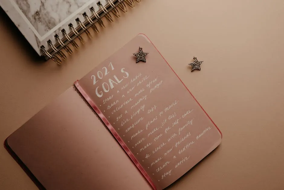 Hands writing a SMART goal on a notebook — specific outcome, measurable target, deadline circled at the bottom
