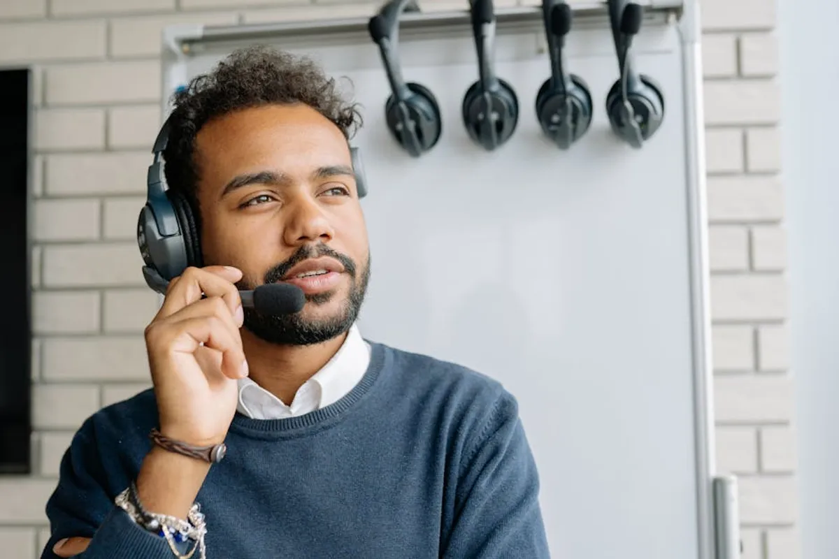 A Singapore customer service professional staying calm at a service counter while listening attentively to an upset customer, with a colleague nearby for support