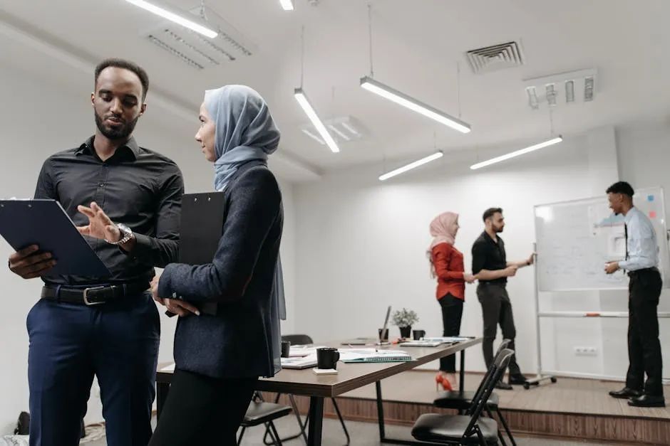A confident speaker holding the floor in a boardroom — gesture mid-sentence, colleagues listening, glass-walled office in the background