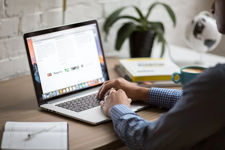 A laptop screen showing a clear, well-structured email subject line and body — clean inbox in the background, professional Singapore office setting